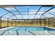 Screened in pool with a view of trees at 2154 Azure Rd, North Port, FL 34286