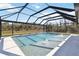 Screened-in pool boasts a geometric design, fountains, and plenty of space for enjoying the outdoors at 2154 Azure Rd, North Port, FL 34286