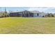 View of screened-in pool and home exterior from the backyard at 2154 Azure Rd, North Port, FL 34286