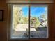 View of backyard with lush foliage and a shed from interior window at 22398 Walton Ave, Port Charlotte, FL 33952