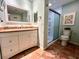 Main bathroom features a shower, toilet and granite vanity at 22398 Walton Ave, Port Charlotte, FL 33952