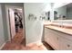 Bathroom boasts granite countertop, white cabinets, and walk-in closet at 22398 Walton Ave, Port Charlotte, FL 33952
