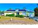 House exterior with solar panels, landscaping, and a garage at 22398 Walton Ave, Port Charlotte, FL 33952