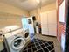 Laundry room with washer, dryer, and extra storage at 22398 Walton Ave, Port Charlotte, FL 33952