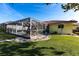 Well-manicured backyard with a screened-in pool and a green lawn at 2240 Via Esplanade, Punta Gorda, FL 33950