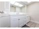 Bright bathroom with a large mirror, white cabinets, and ample counter space at 2240 Via Esplanade, Punta Gorda, FL 33950
