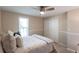 Cozy bedroom featuring neutral tones, a ceiling fan, and a window with natural light at 2240 Via Esplanade, Punta Gorda, FL 33950