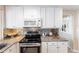 Kitchen view with stainless steel appliances, granite countertops, backsplash, and white cabinets at 2240 Via Esplanade, Punta Gorda, FL 33950