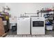 Functional laundry room with washer, dryer, sink, and organized storage solutions at 2240 Via Esplanade, Punta Gorda, FL 33950