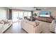 Bright living room with tile floors, sliding glass doors to the lanai, and modern furnishings at 2240 Via Esplanade, Punta Gorda, FL 33950