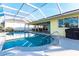Lovely backyard features screened-in pool, covered patio, and outdoor seating at 2240 Via Esplanade, Punta Gorda, FL 33950