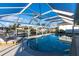 A sparkling pool with sun loungers is enclosed in a screened lanai at 2240 Via Esplanade, Punta Gorda, FL 33950