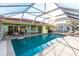 Wide angle of backyard featuring a screened pool, patio, and outdoor seating at 2240 Via Esplanade, Punta Gorda, FL 33950