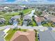 Community aerial showcasing houses along a waterway and golf course at 24509 Bramhope Ct, Punta Gorda, FL 33980