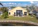 Aerial view of backyard overlooking a pond, large screened-in patio with seating at 24509 Bramhope Ct, Punta Gorda, FL 33980