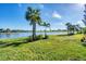 Landscaped backyard with lake view at 25228 Longmeadow Dr, Punta Gorda, FL 33955