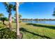 Landscaped backyard with lake view at 25228 Longmeadow Dr, Punta Gorda, FL 33955