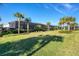 Spacious backyard with lush landscaping and screened patio at 25228 Longmeadow Dr, Punta Gorda, FL 33955