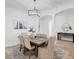 Bright dining room with large table and modern chandelier at 25228 Longmeadow Dr, Punta Gorda, FL 33955