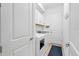 Bright laundry room with washer, dryer, and cabinets at 25228 Longmeadow Dr, Punta Gorda, FL 33955