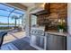 Stainless steel appliances and stonework in outdoor kitchen at 25228 Longmeadow Dr, Punta Gorda, FL 33955