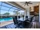 Outdoor dining area with pool and built-in grill at 25228 Longmeadow Dr, Punta Gorda, FL 33955