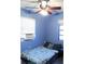 Blue bedroom with a double bed and window at 2544 Elkcam Blvd, Port Charlotte, FL 33952