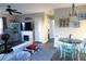 Open concept dining area with teal chairs and a round table at 2544 Elkcam Blvd, Port Charlotte, FL 33952