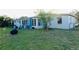 Tan house with a spacious backyard at 2544 Elkcam Blvd, Port Charlotte, FL 33952