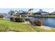 Relaxing view of canal with boat and lush landscaping at 2807 Sancho Panza Ct, Punta Gorda, FL 33950