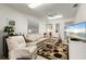 Relaxing living room with light beige sofa and ceiling fan at 2807 Sancho Panza Ct, Punta Gorda, FL 33950