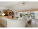 Living area with curved sectional sofa and access to patio at 2807 Sancho Panza Ct, Punta Gorda, FL 33950