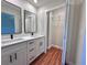 Bright bathroom featuring a double sink vanity and a large walk-in closet at 2920 Barry Rd, North Port, FL 34286