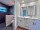 Bathroom featuring a double sink vanity and a modern tiled shower at 2920 Barry Rd, North Port, FL 34286