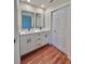 Bathroom featuring a double sink vanity and a large closet at 2920 Barry Rd, North Port, FL 34286