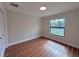 Bright bedroom with wood-look floors, a closet, and a sun-filled window at 2920 Barry Rd, North Port, FL 34286