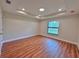 Bright bedroom with hardwood floors and a large window at 2920 Barry Rd, North Port, FL 34286