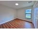 Bright bedroom with wood-look floors, a closet, and a sun-filled window at 2920 Barry Rd, North Port, FL 34286