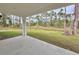 Spacious covered patio overlooking a private backyard with lush landscaping at 2920 Barry Rd, North Port, FL 34286