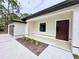 Modern home exterior with a two-car garage and landscaped front yard at 2920 Barry Rd, North Port, FL 34286