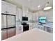 Bright kitchen featuring white cabinets, quartz countertops, stainless steel appliances, and modern black hardware at 2920 Barry Rd, North Port, FL 34286