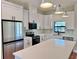 Bright kitchen featuring white cabinets, quartz countertops, stainless steel appliances, and modern black hardware at 2920 Barry Rd, North Port, FL 34286