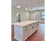 Large kitchen island with white cabinets and quartz countertops at 2920 Barry Rd, North Port, FL 34286