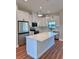 Modern kitchen featuring stainless steel appliances, white cabinets, and a large quartz island at 2920 Barry Rd, North Port, FL 34286