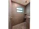 Modern tiled shower featuring a window and a built-in shelf at 2920 Barry Rd, North Port, FL 34286