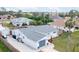 Aerial view showcases a renovated home with a gray roof and fenced backyard at 325 San Benito Ave, North Port, FL 34287