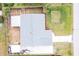 Overhead view of a single-story house with a gray roof and fenced yard at 325 San Benito Ave, North Port, FL 34287