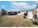 Spacious backyard with fire pit, rocking chairs and screened porch at 325 San Benito Ave, North Port, FL 34287