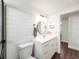 Clean bathroom with a toilet, vanity, and built-in shelving at 325 San Benito Ave, North Port, FL 34287