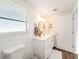Modern bathroom with white vanity, a large mirror, and updated fixtures at 325 San Benito Ave, North Port, FL 34287